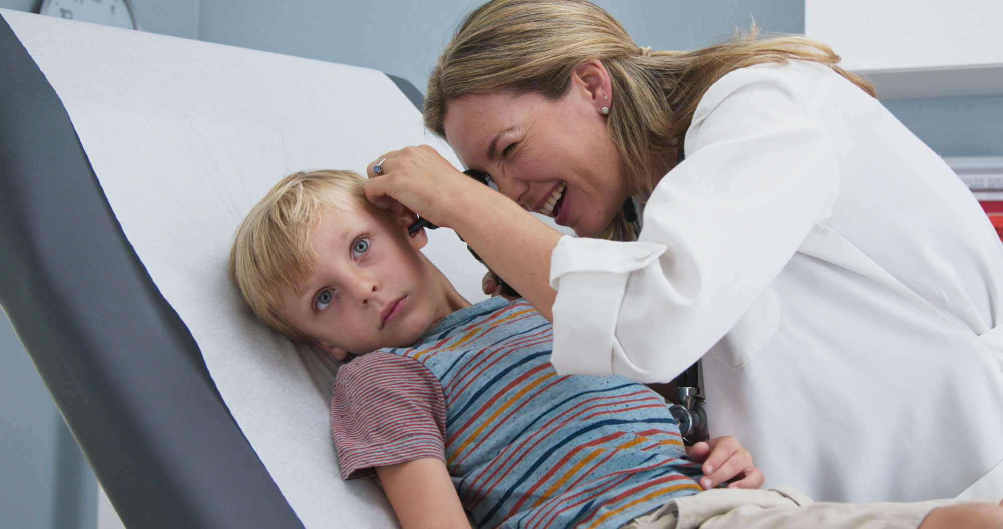 nurse examines child’s ear